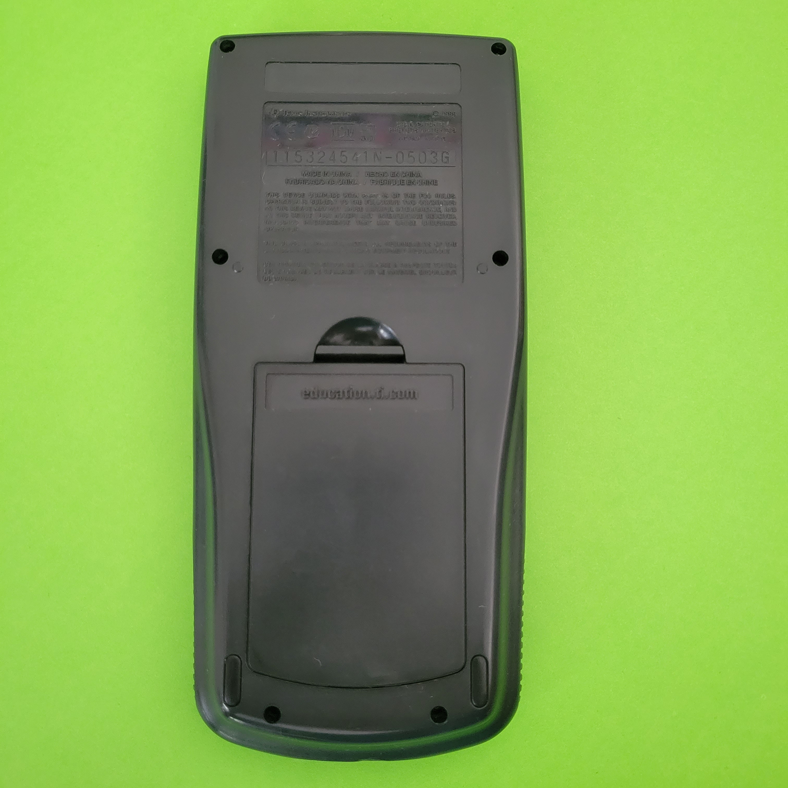An image of the back of a texas instruments ti83 plus graphing calculator
